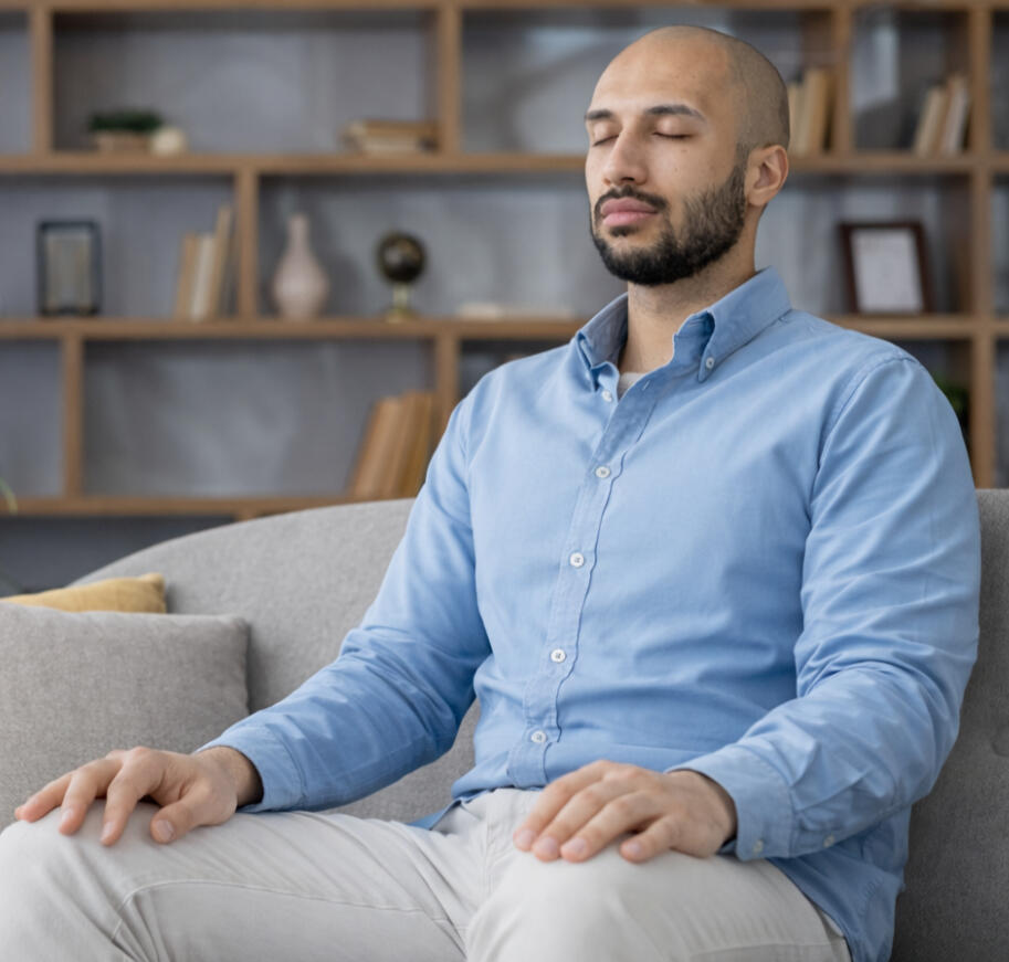 Mother sitting on a bed holding her baby while looking tired and overwhelmed during a difficult moment after childbirth